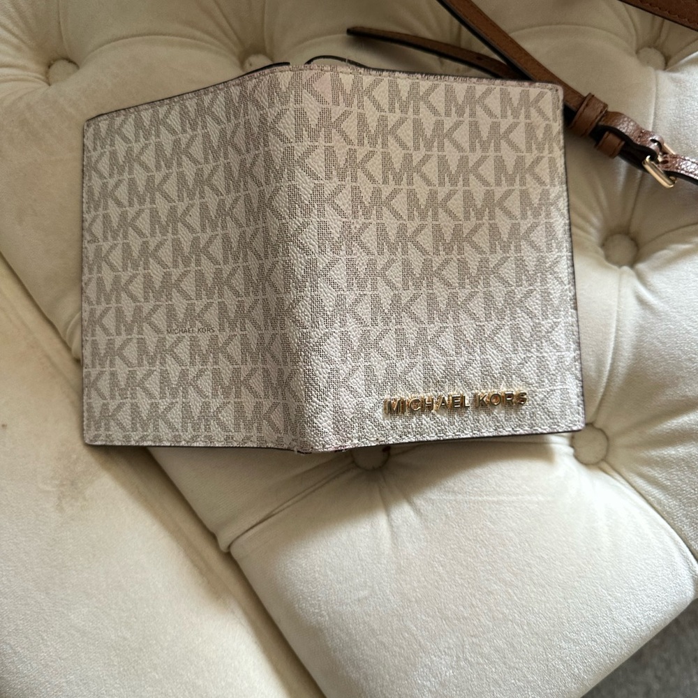 Used Michael Kors passport wallet. Some wear and tear